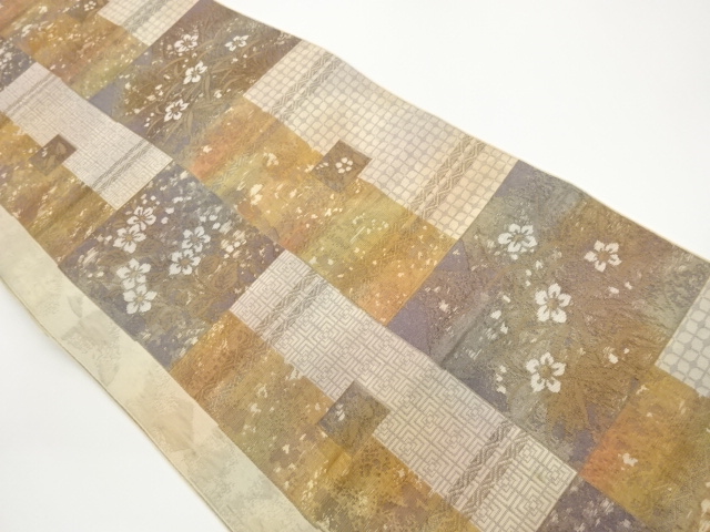 Nagoya obi with woven geometric pattern of flowers and plants on colored paper